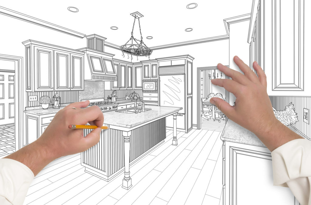 Male Hands Sketching with Pencil the Outline of a Beautiful Custom Kitchen.