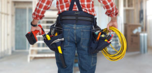 Electrician man with drill and wire cable.